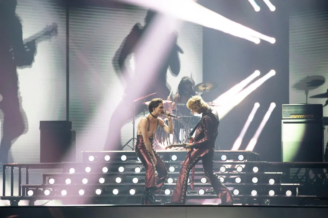 Singer and guitarist face to face in front of the illuminated drum riser – Måneskin at Eurovision 2021, Rotterdam, Netherlands – concert stage design