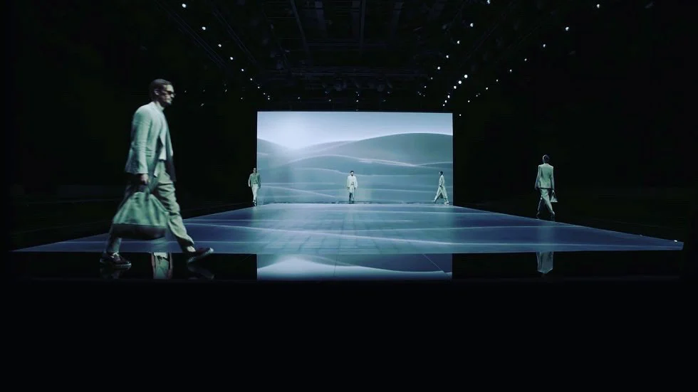 Models crossing a mirrored runway in front of an LED wall showing pale rolling dunes – Giorgio Armani SS21 Womenswear, Milan, Italy, 2021 – fashion show set design