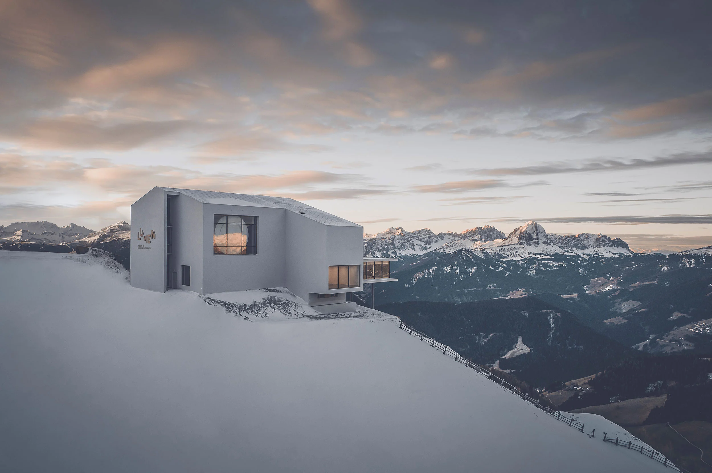 LUMEN Museum on the snowy summit of Kronplatz at sunset, a white building with large windows facing the Dolomites – Lumen Museum of Mountain Photography, Kronplatz, Italy, 2018 – architecture