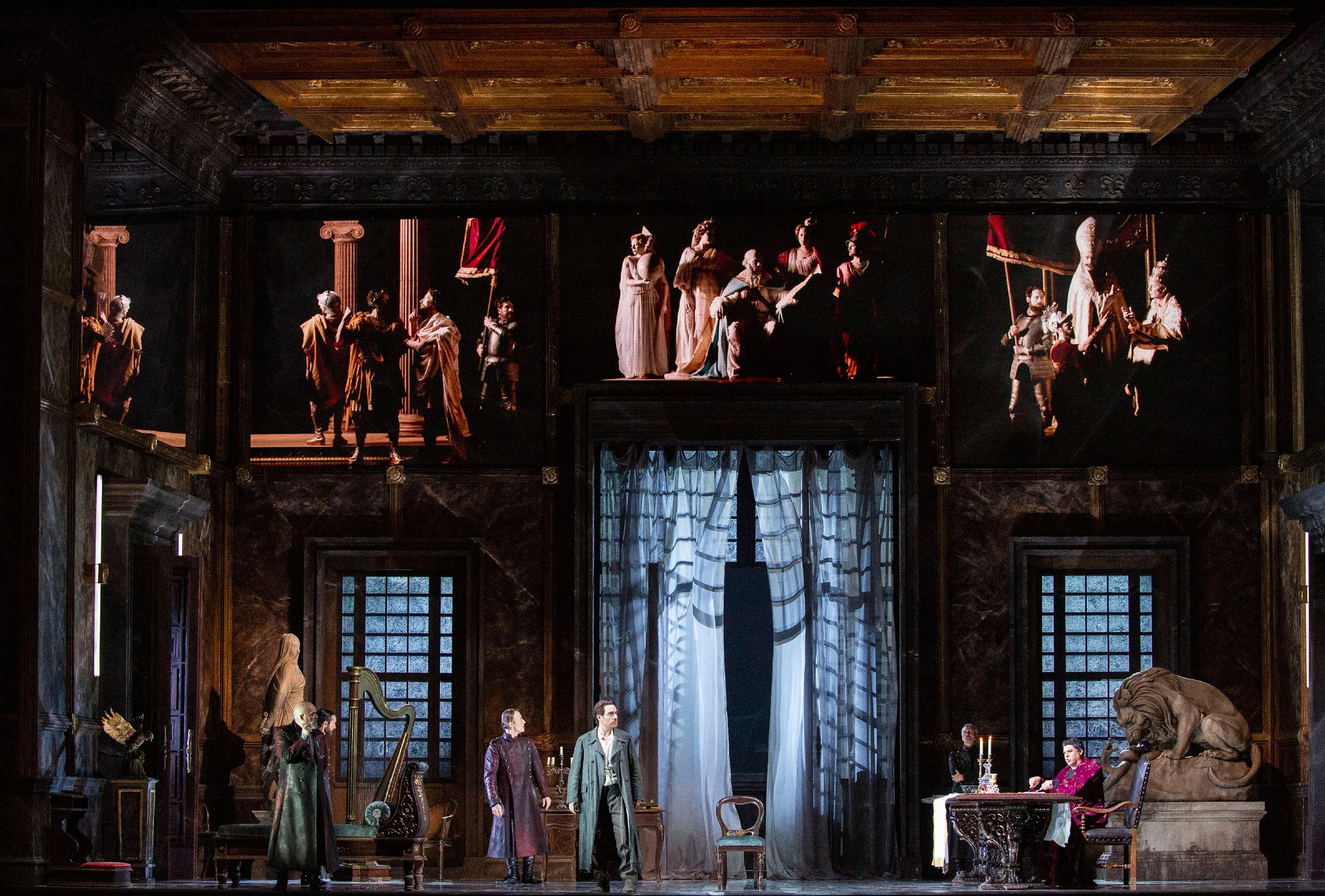 Palace interior set with coffered ceiling and tableaux of costumed figures above the singers – Tosca at La Scala, Milan, Italy, 2019 – opera set design