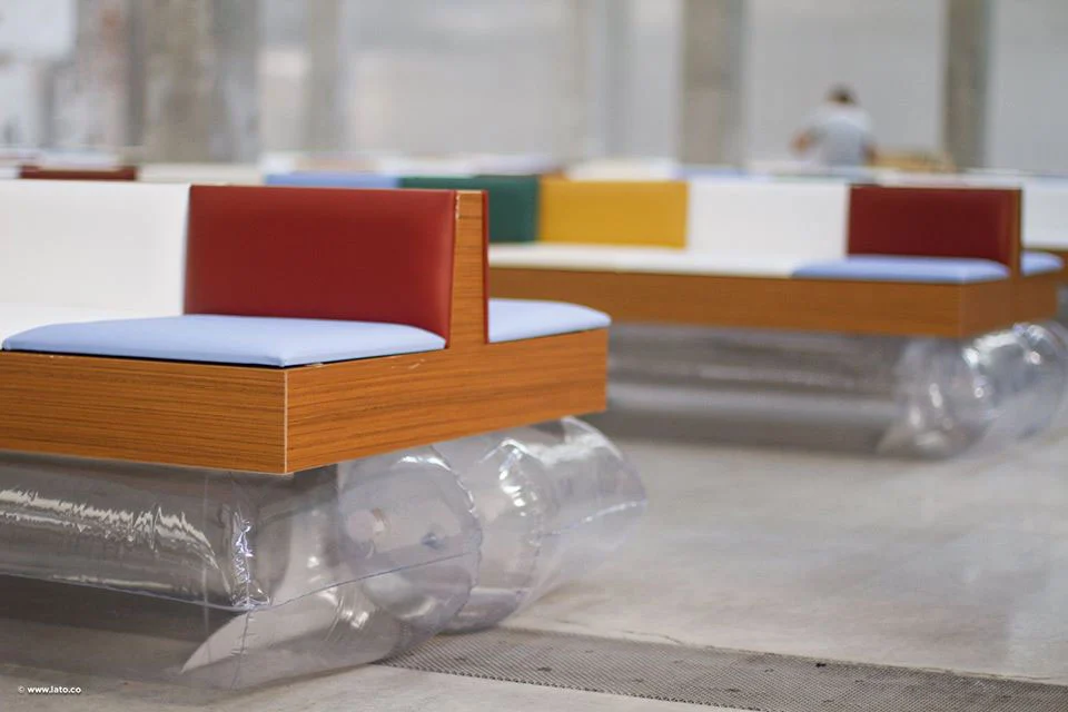Close-up of a bench with red and blue cushions on a wooden frame and clear inflatable supports – Marni Spring 2017 Ready-to-Wear, Milan, Italy – fashion show set design