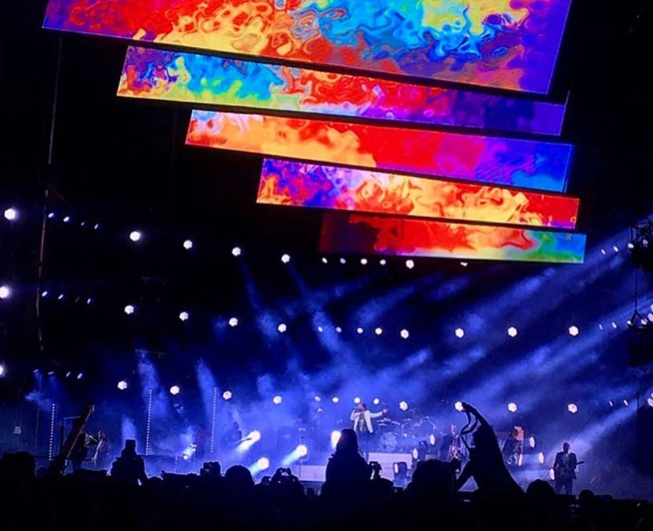 Layered video bars in swirling colours above the band, white beams cutting through smoke – Cesare Cremonini Stadi 2018, Italy – concert stage design