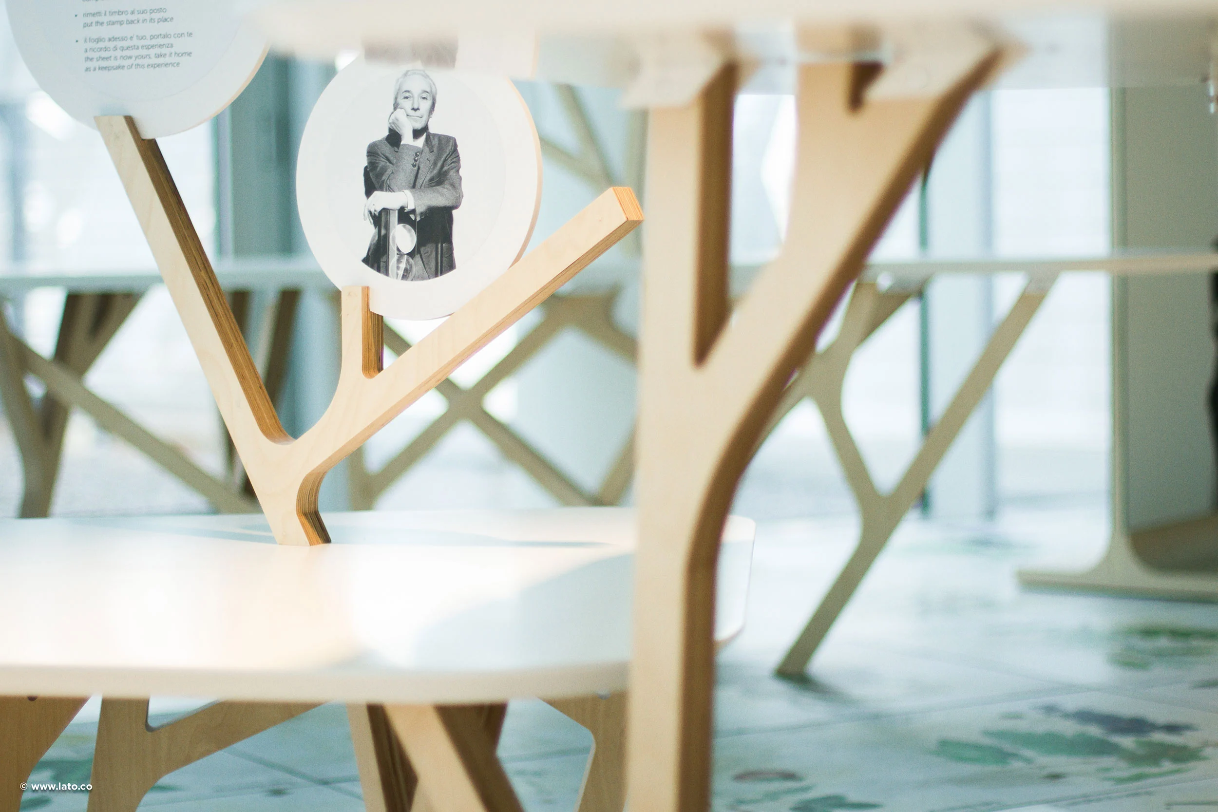 Detail of branching wooden table supports holding round portrait cards in the pavilion exhibition – Italian Pavilion at Expo 2015, Milan, Italy – exhibition design
