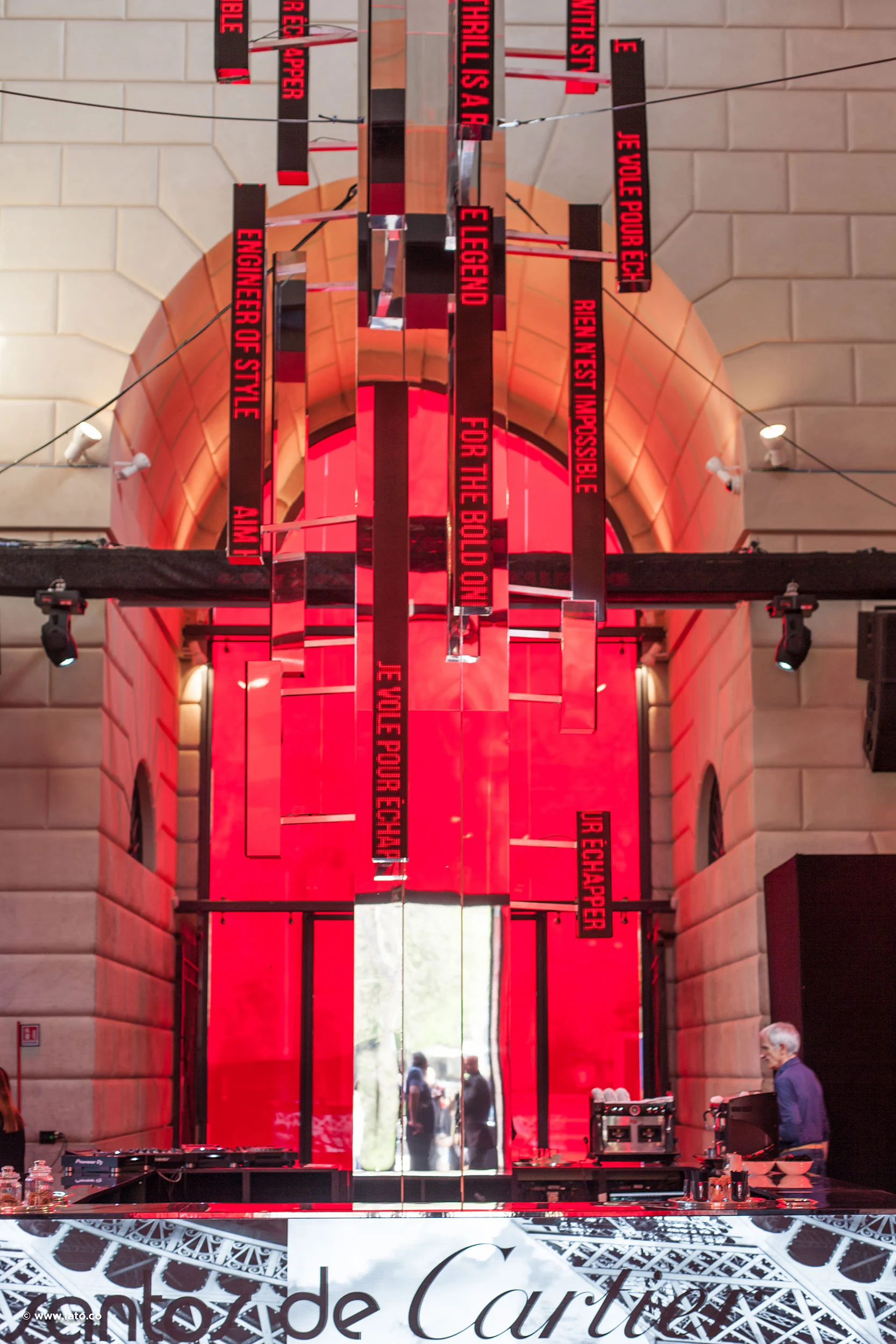 Hanging red message boards and mirrored strips under a stone vault, Santos de Cartier below – Cartier The Legendary Thrill, Milan, Italy, 2018 – event design
