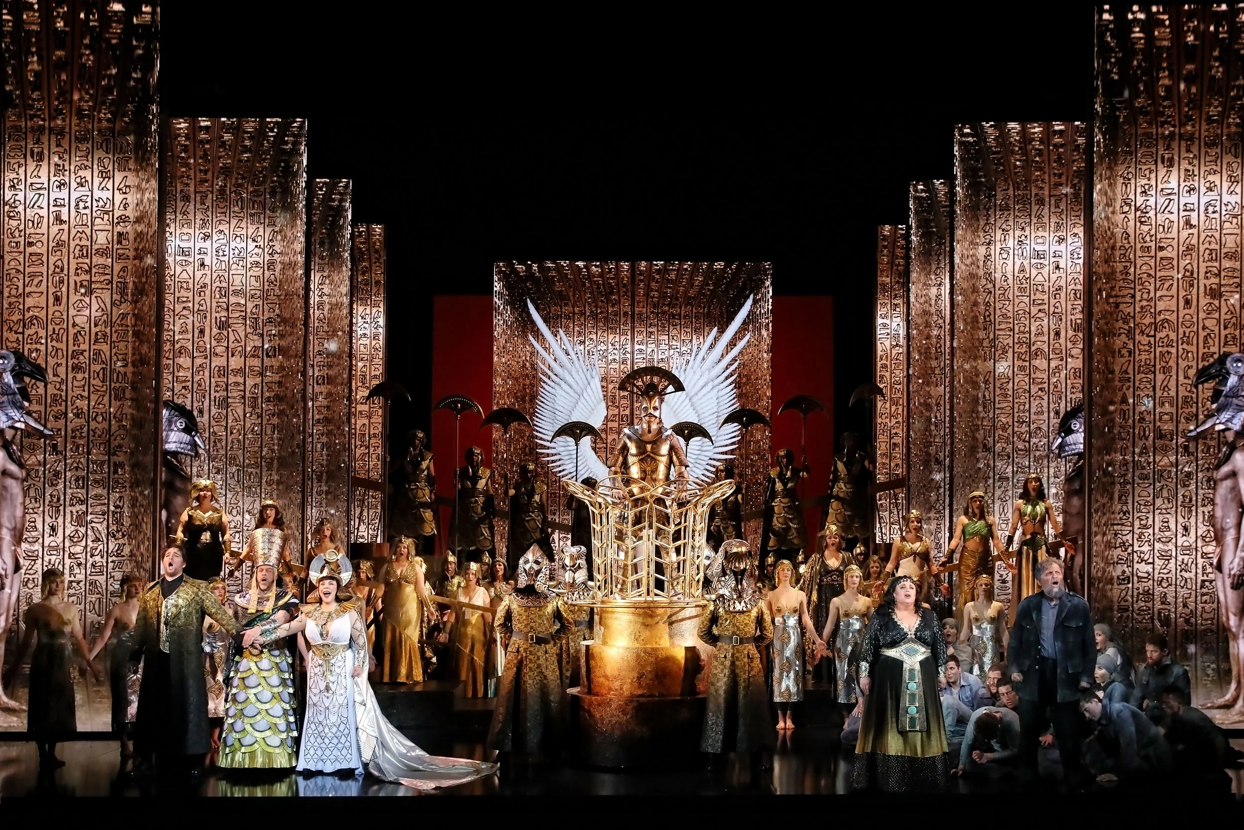 Aida finale: full cast before towering gold walls carved with hieroglyphs and a winged golden idol – Aida at Sydney Opera House, Australia, 2018 – set design