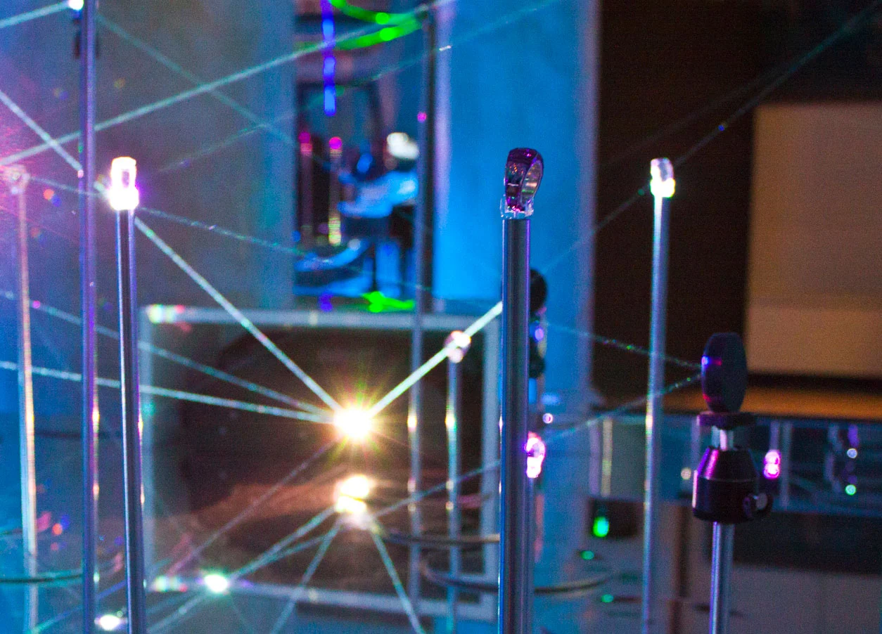 Close-up of the laser installation: glowing tips of metal rods linked by fine beams of light – Swarovski Fashionation Party at Palazzo Reale, Milan, Italy, 2011 – event design