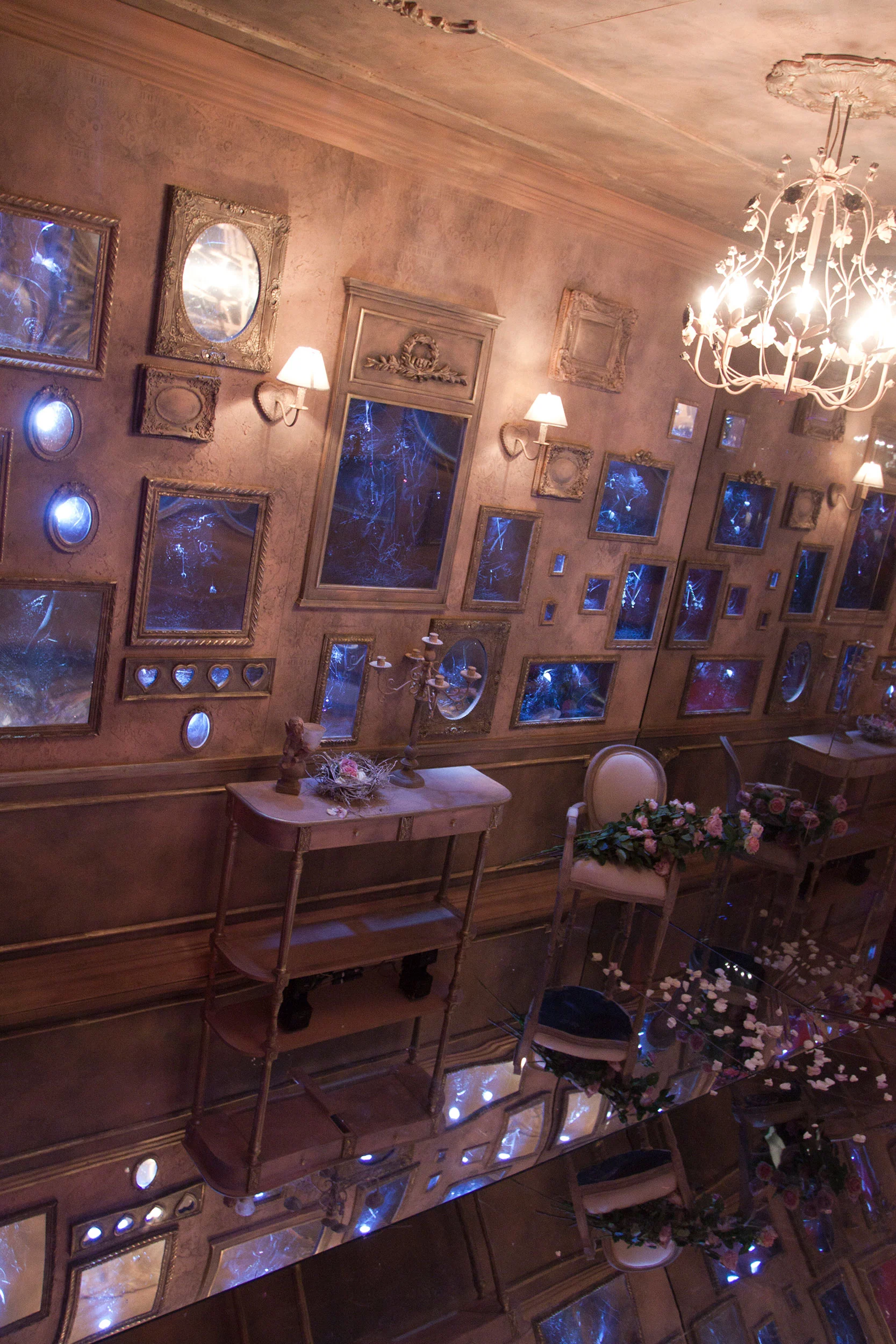 Mirrored room of antique gilded frames, wall lamps, chandelier and flower-decked chairs, seen from above – Swarovski Fashionation Party at Palazzo Reale, Milan, Italy, 2011 – event design