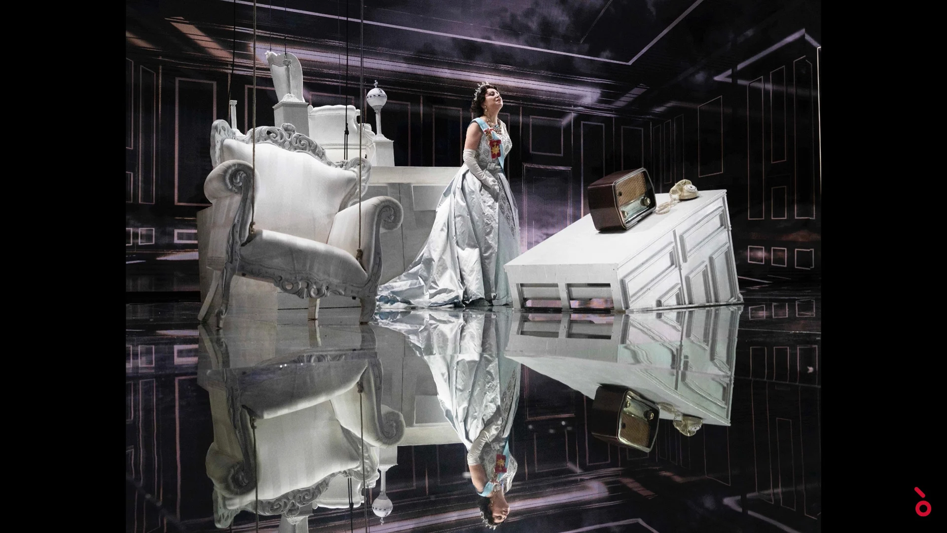 The queen in a silver gown among white baroque furniture, reflected in the mirrored floor – Elisabetta, Regina d'Inghilterra at Rossini Opera Festival, Pesaro, Italy, 2021 – set design