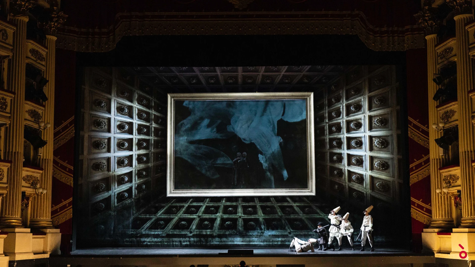 Masked figures in white before a giant gilded frame inside a coffered, ornamented box set – La Gioconda at La Scala, Milan, Italy, 2022 – opera set design
