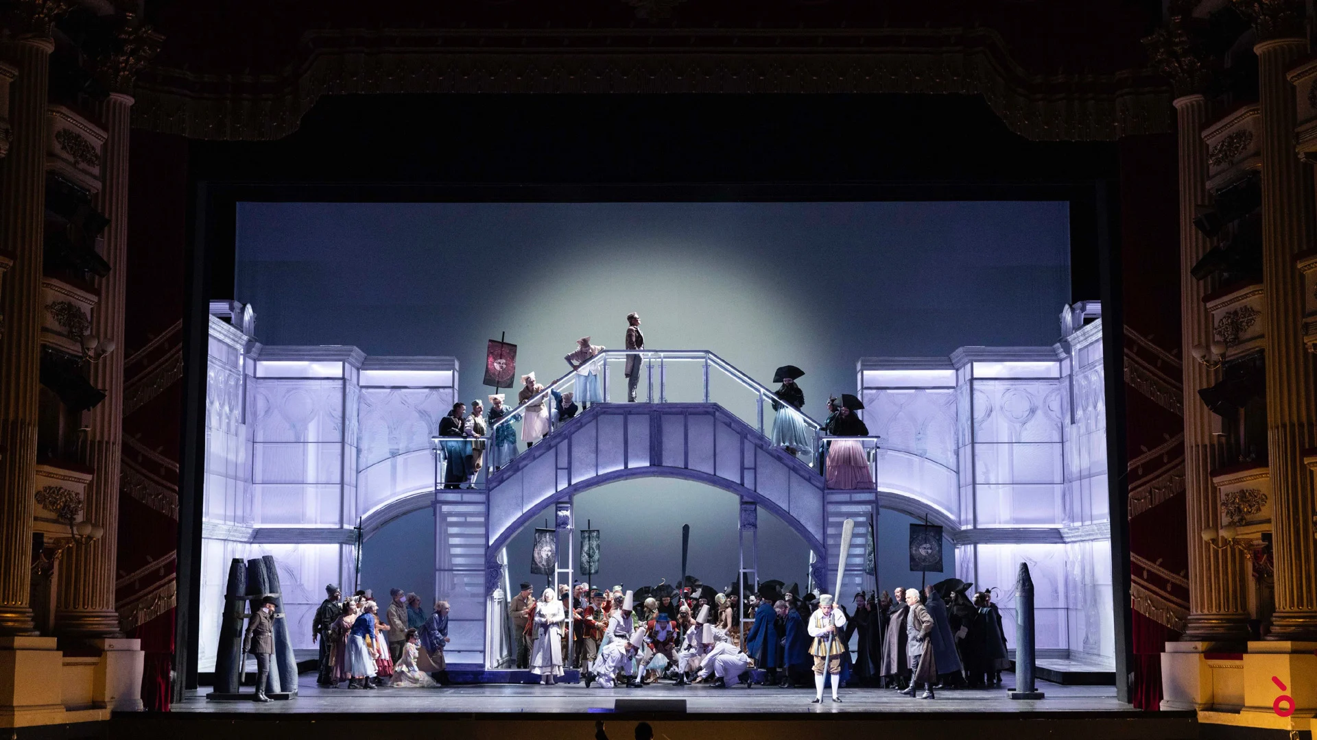 Chorus on a pale double staircase and bridge under a spotlight, a soloist at the front of the stage – La Gioconda at La Scala, Milan, Italy, 2022 – opera set design
