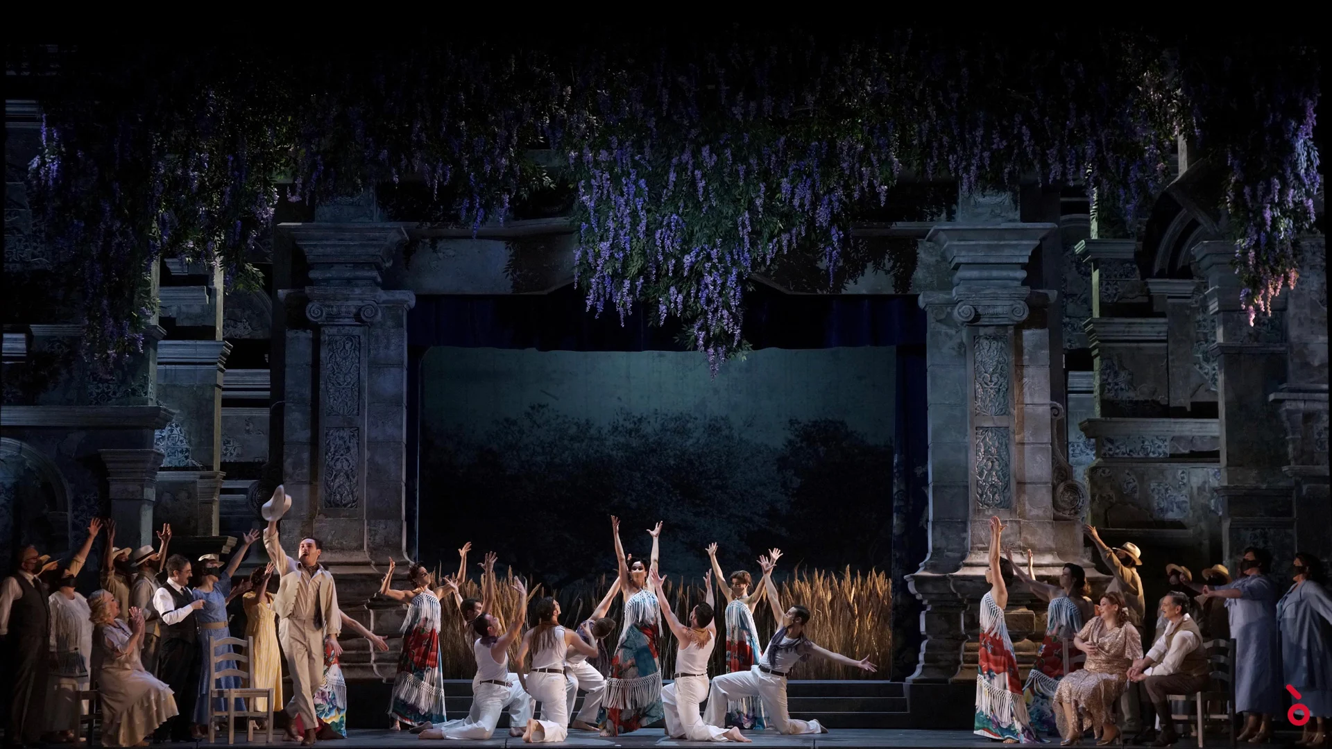 Dancers with raised arms before the stone facade draped in hanging wisteria, a wheat field behind – Luisa Fernanda at Teatro de la Zarzuela, Madrid, Spain, 2021 – opera set design