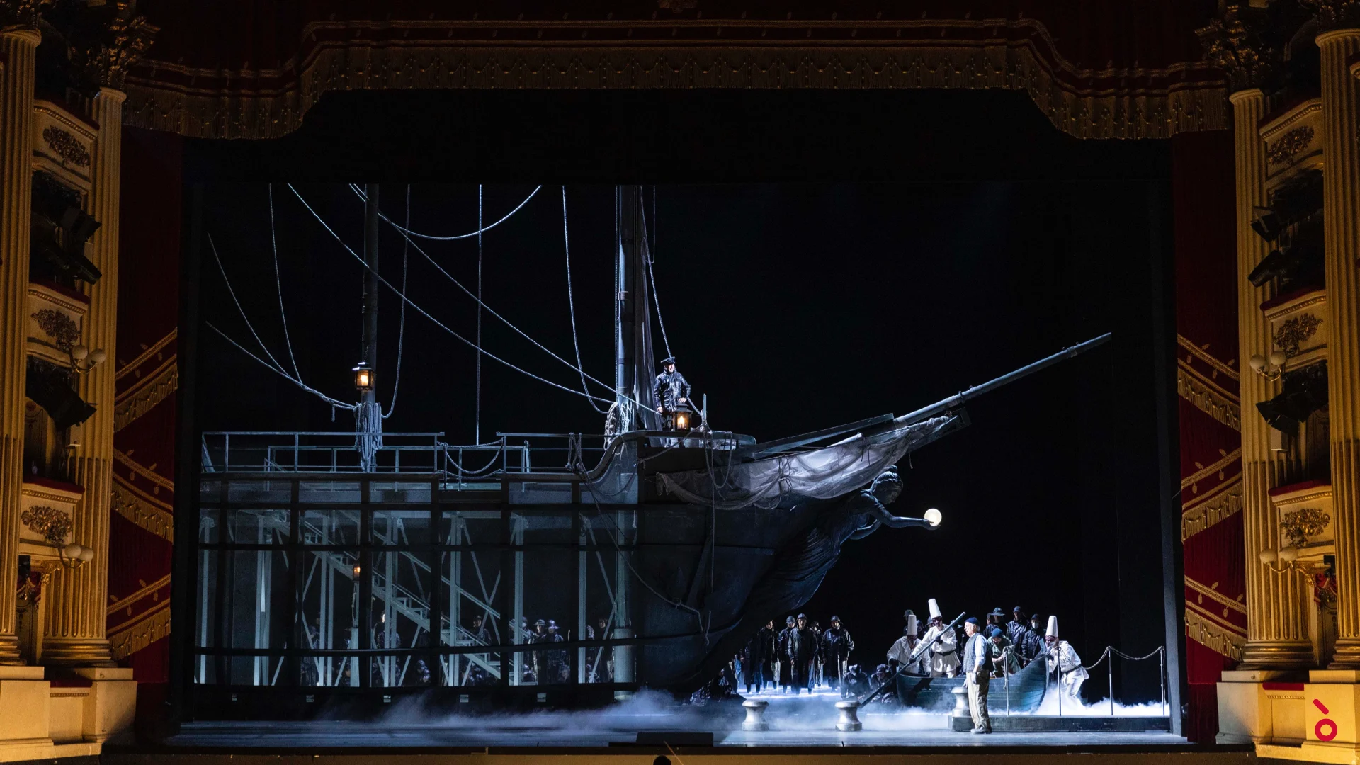 The galleon set on the Scala stage: a dark ship with tall masts and rigging over misty water, chorus at the bow – La Gioconda at La Scala, Milan, Italy, 2022 – opera set design