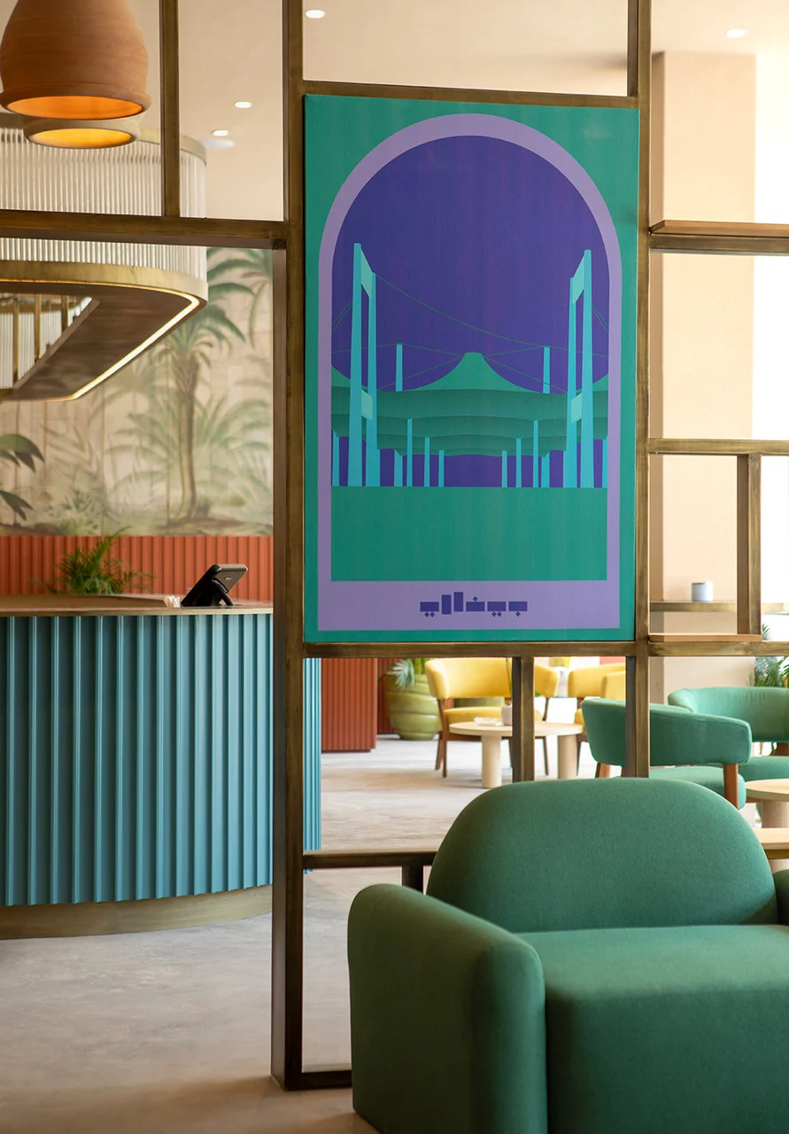 Cafe with green armchairs, a teal fluted counter and a framed poster of the terminal canopies – Islamic Arts Biennale, Jeddah, Saudi Arabia, 2023 – architecture