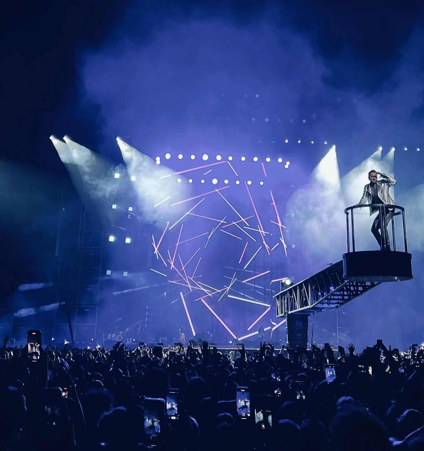 Cesare Cremonini on a raised platform at the end of a bridge, laser lines on the LED wall behind – Cesare Cremonini Stadi 2022, Italy – concert stage design