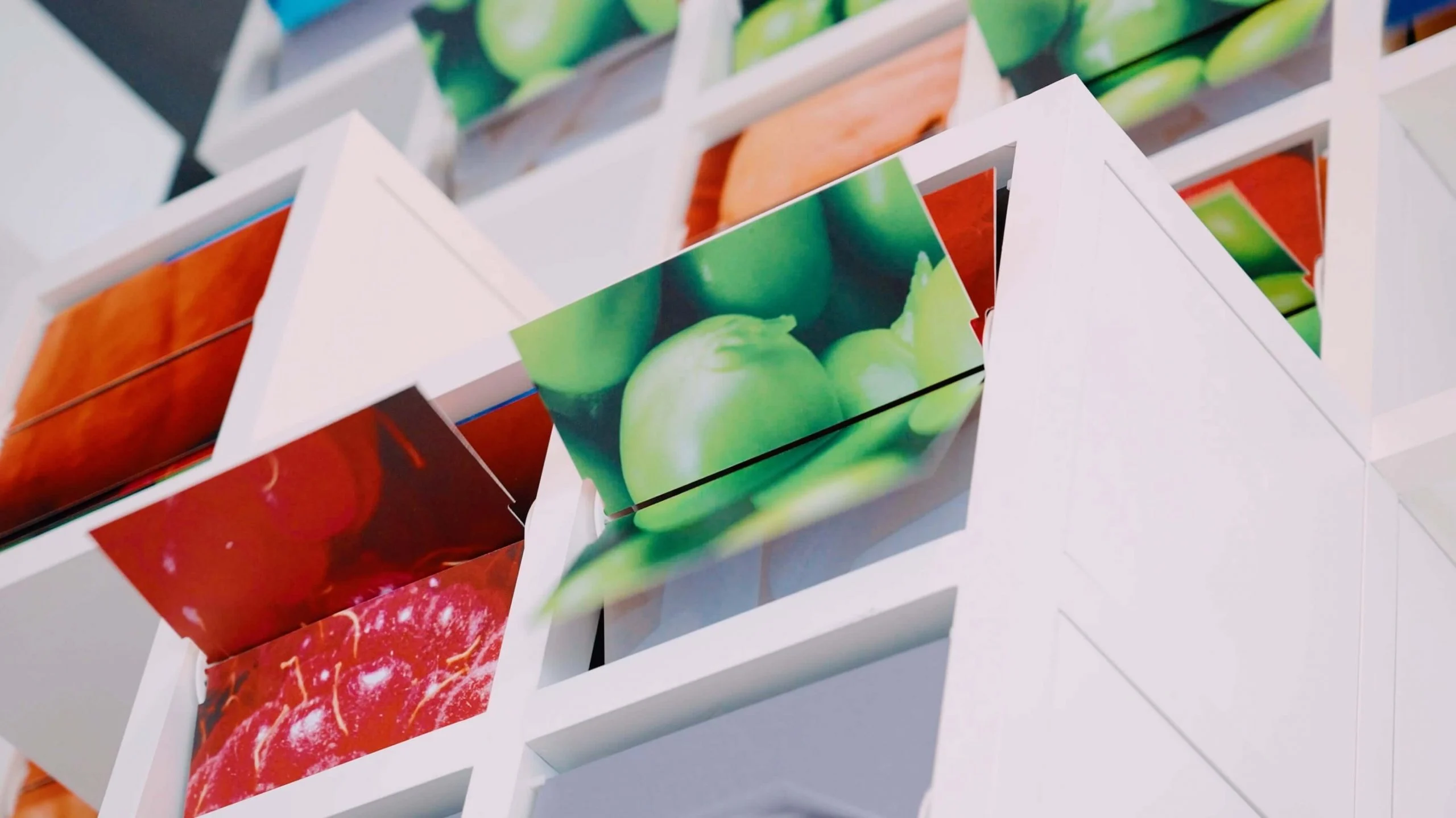 Close-up of La Nuvola modules: white cubes with flipping panels showing photographs of fruit – La Nuvola at Cirfood District, Reggio Emilia, Italy, 2022 – kinetic installation design