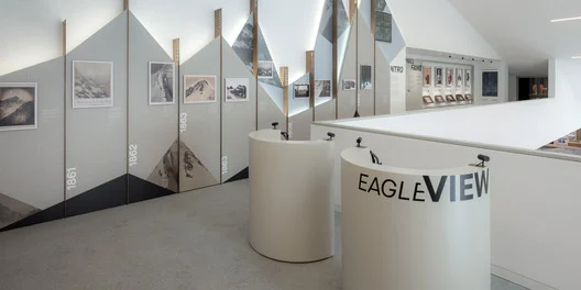 Eagle View virtual reality stations in front of a wall timeline of mountain photographs dated from 1861 – Lumen Museum of Mountain Photography, Kronplatz, Italy, 2018 – architecture