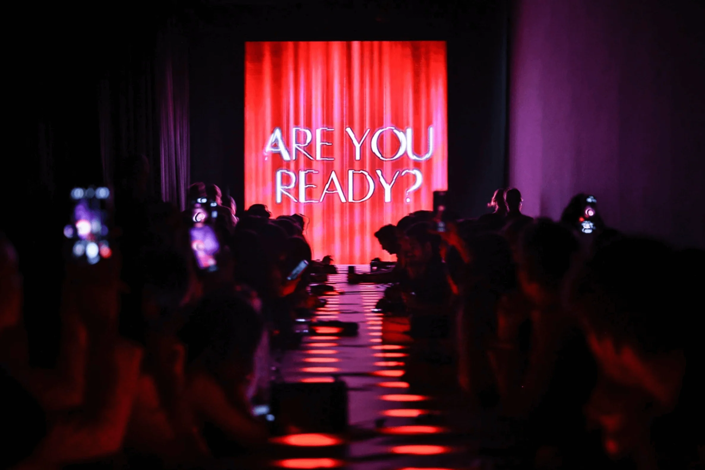 Red LED screen reading Are You Ready? at the end of a lit runway lined with guests – Campari Discover Red Party at Cannes Film Festival, France, 2023 – event design