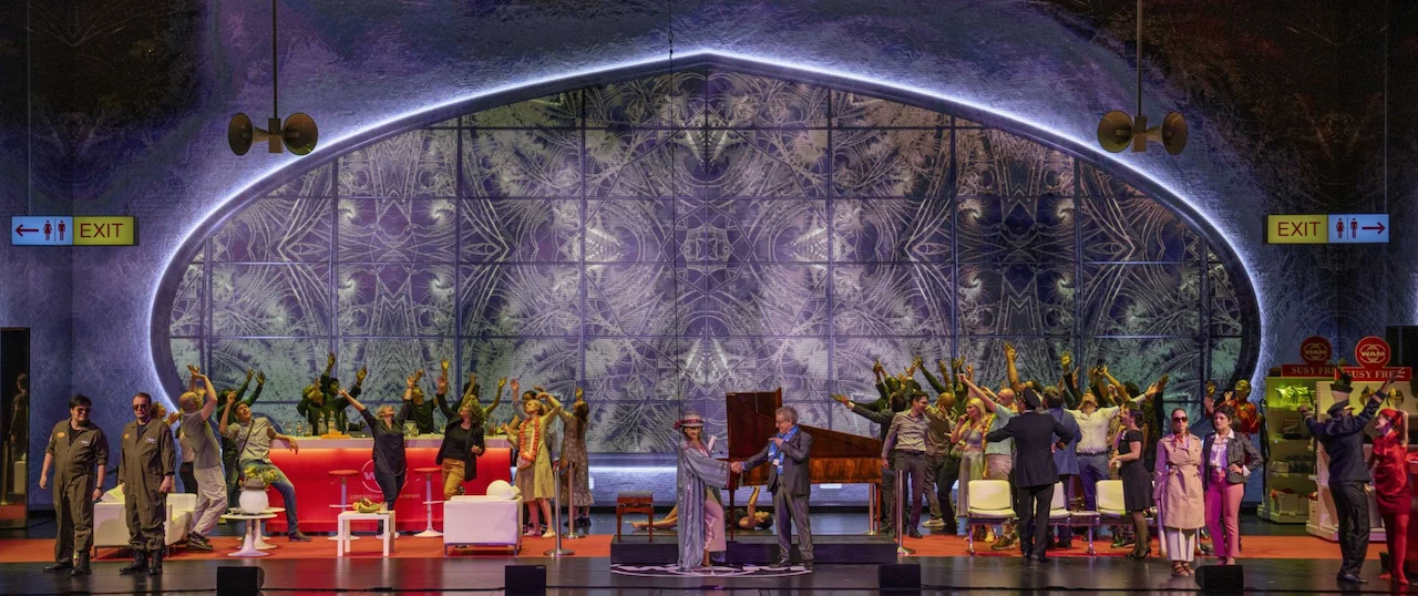 Cast dancing with raised arms before a kaleidoscopic projection in the oval window, a piano centre stage – Une Folle Journée Mozart Gala, Salzburg, Austria, 2024 – opera set design