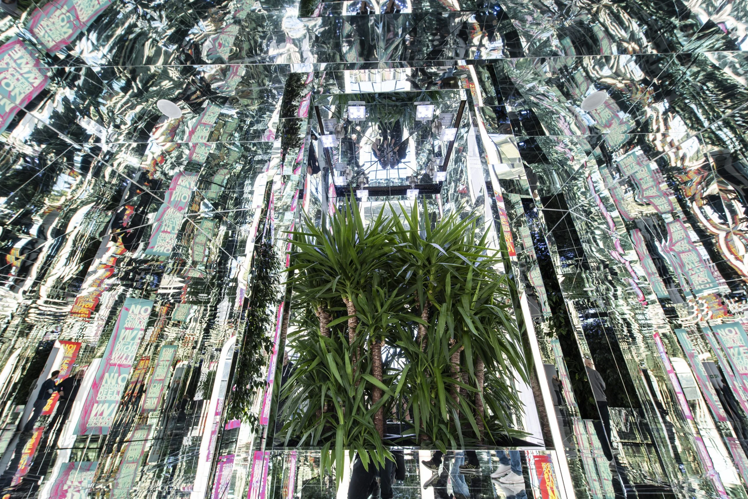 Kaleidoscopic mirror room with a potted palm at its centre, multiplied by reflections on every side – La Nazione delle Piante at Triennale, Milan, Italy, 2019 – exhibition design
