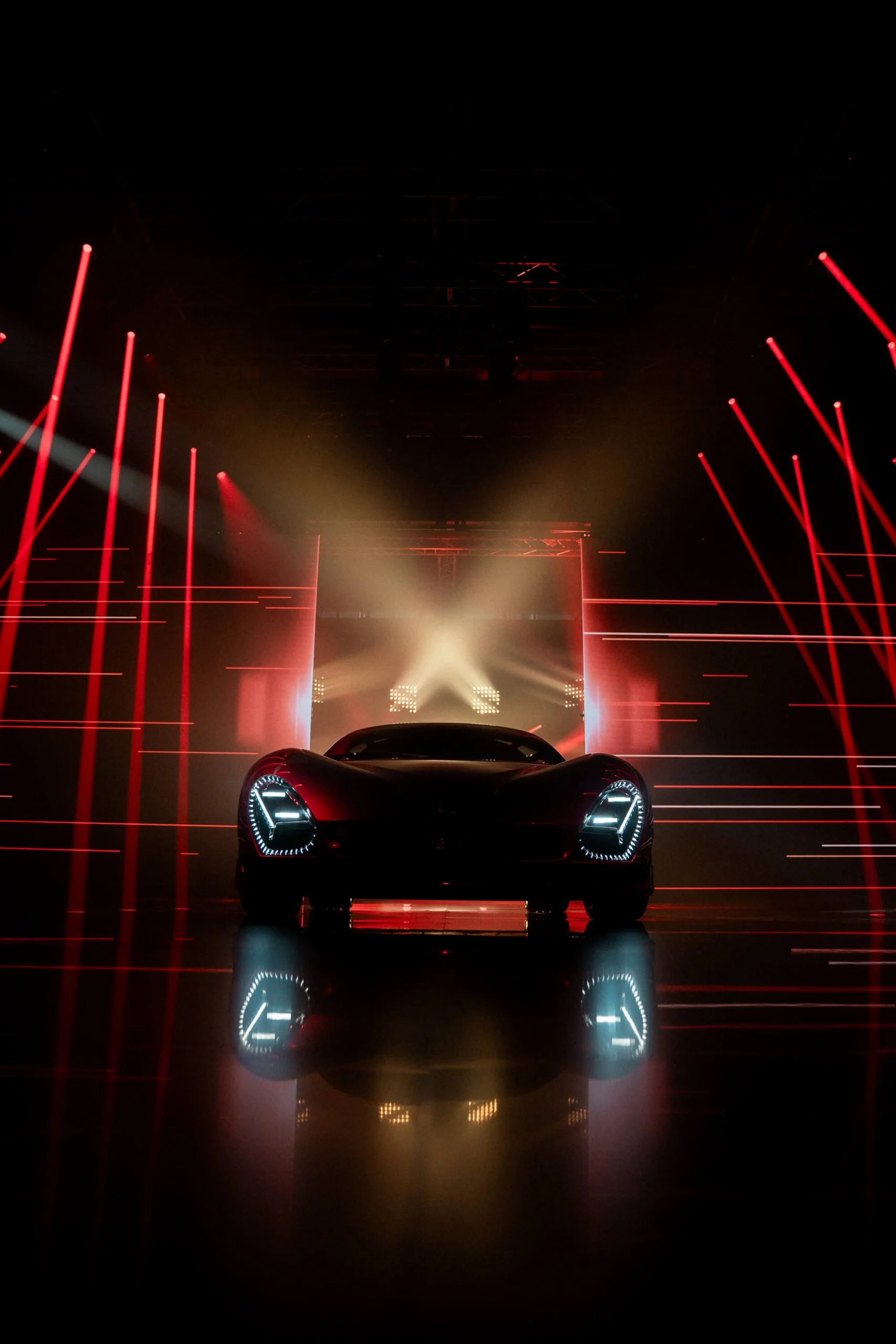 Front of the new 33 Stradale with glowing headlights, framed by red laser lines and a white light cross – Alfa Romeo 33 Stradale Unveiling, Arese, Italy, 2023 – event design