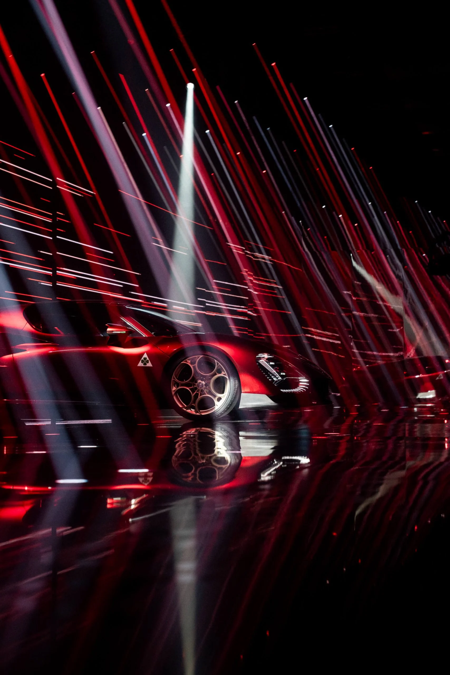 Red 33 Stradale in profile behind a dense curtain of red and white light streaks – Alfa Romeo 33 Stradale Unveiling, Arese, Italy, 2023 – event design