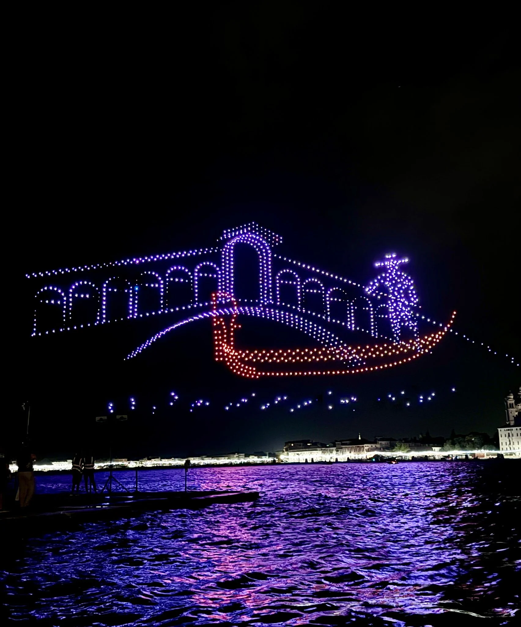 Drones forming an arched bridge and a gondola with gondolier above the water at night – Aperol Redentore Drone Show, Venice, Italy, 2024 – creative direction