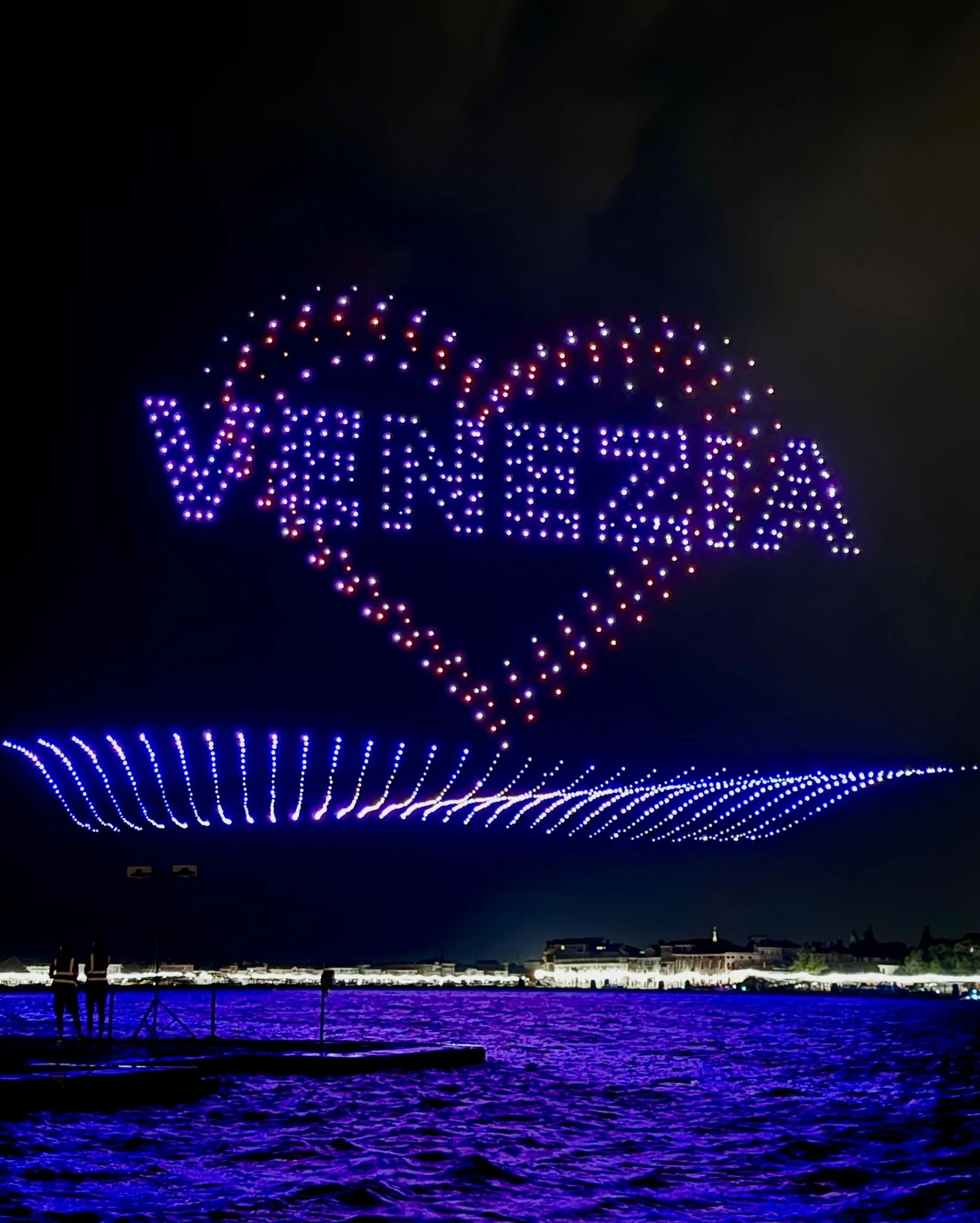 Drones spelling Venezia inside a heart, above a wave of blue lights over the lagoon – Aperol Redentore Drone Show, Venice, Italy, 2024 – creative direction