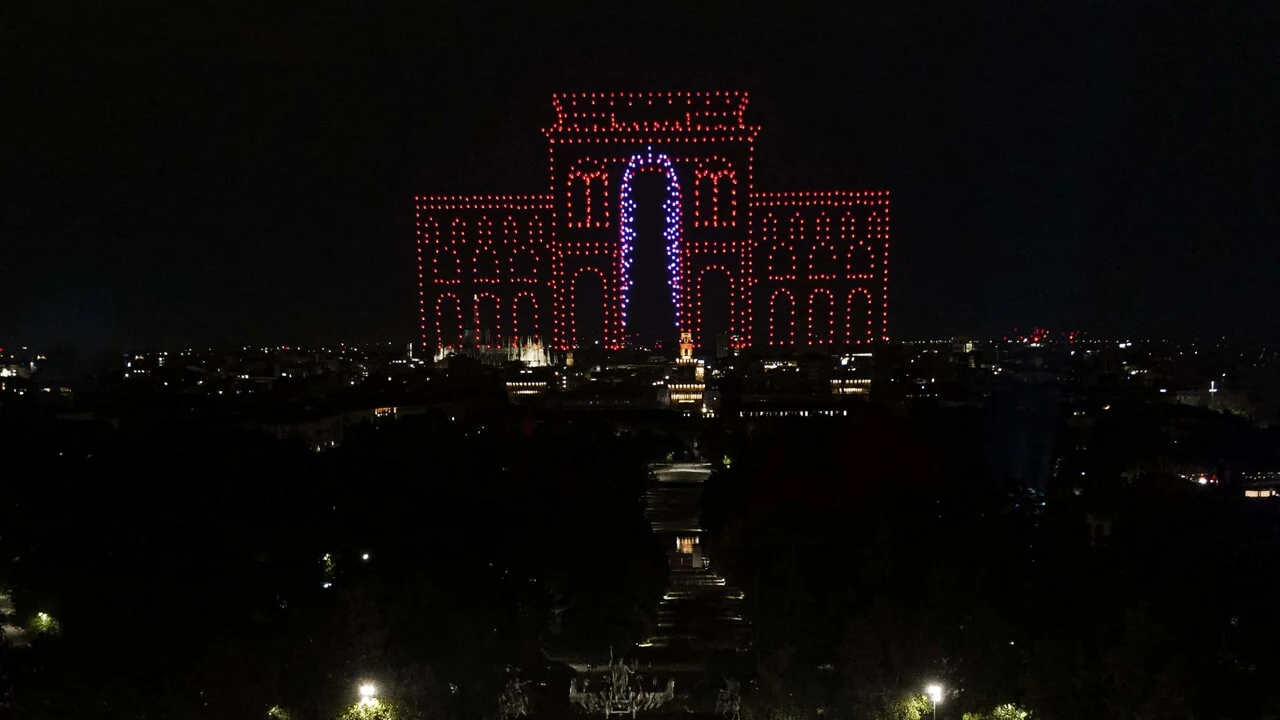Drones tracing the arched facade of Galleria Vittorio Emanuele in red and blue lights above Milan at night – Milano House of Campari, Italy, 2023 – event design