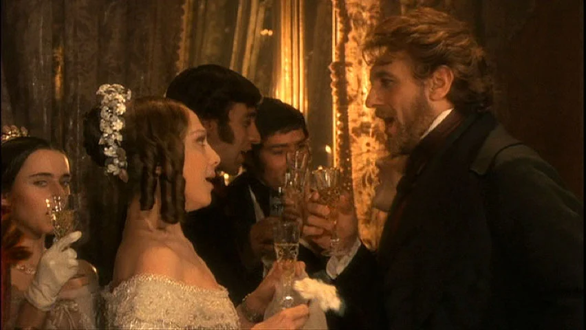 Film still: guests in period costume toasting with champagne in a gilded salon – The Opera! Arie per un'Eclissi at Rome Film Festival, Italy, 2024 – set design