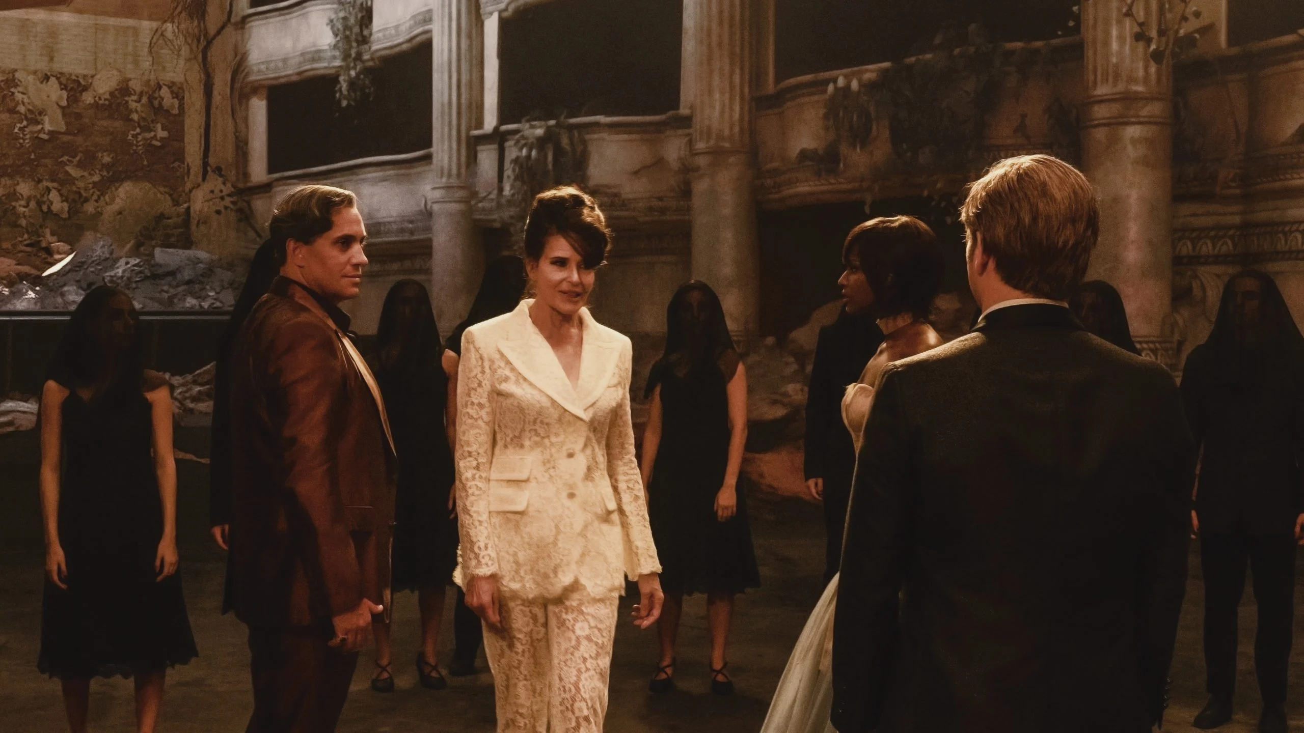 Film still: a woman in a white lace suit among figures in black inside a ruined theatre – The Opera! Arie per un'Eclissi at Rome Film Festival, Italy, 2024 – set design