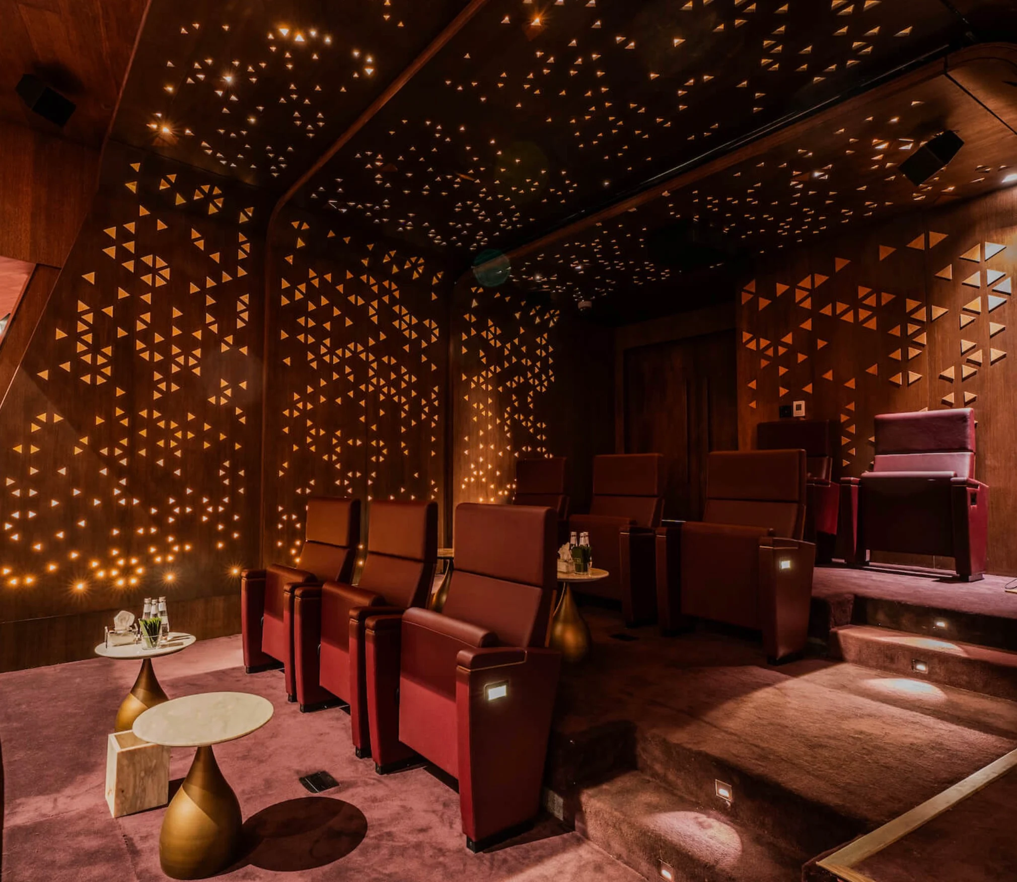 Theatre box with red King Fahad chairs and brass side tables, walls pierced with triangular lights – King Fahad Chair for Poltrona Frau, Riyadh, Saudi Arabia, 2024 – product design