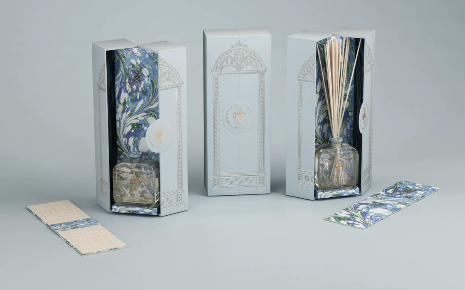 Render of the diffuser boxes with blue and green marbled lining and reeds in a glass bottle – Santa Maria Novella Home Fragrances, 2021 – graphic design proposal