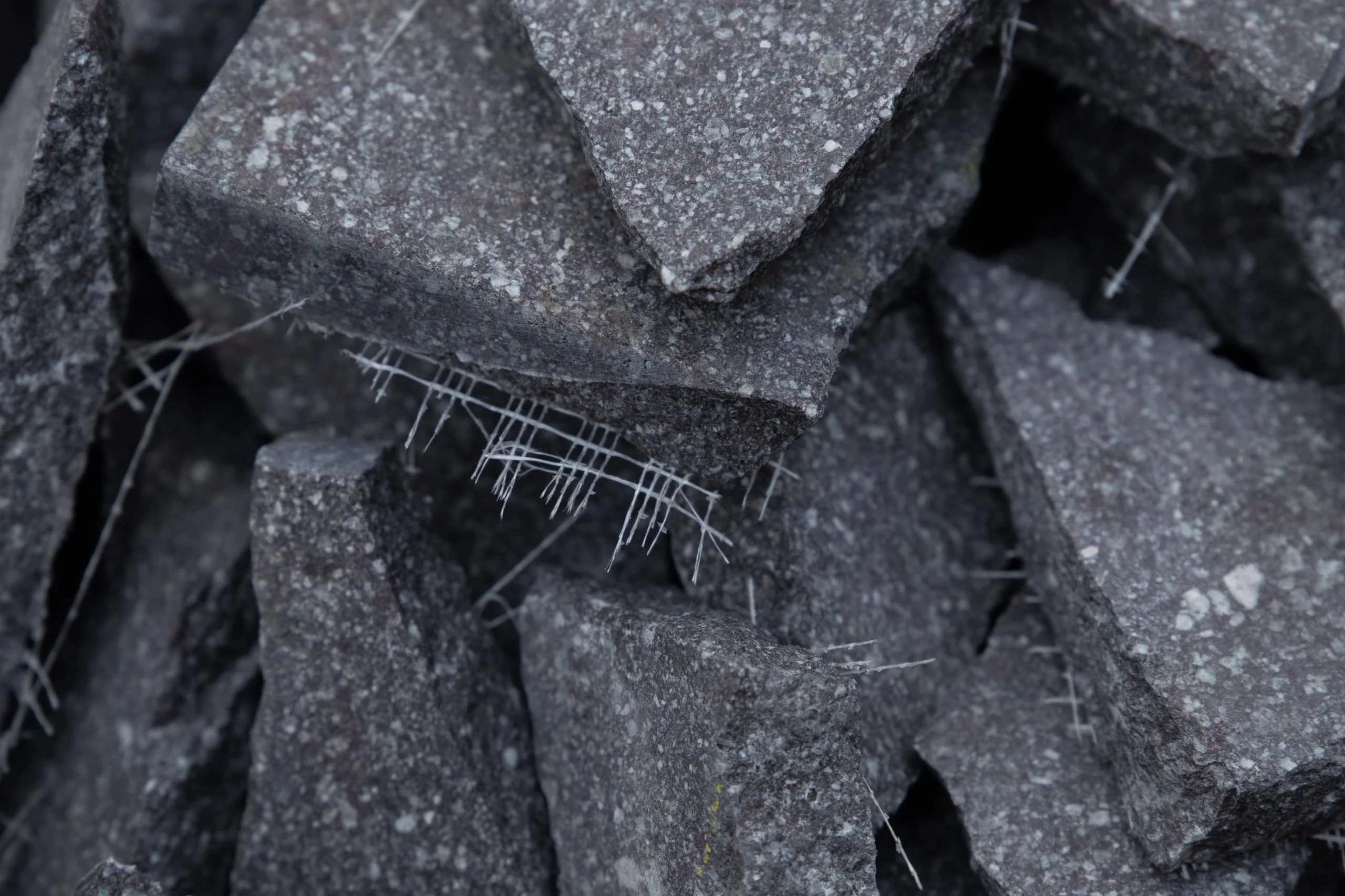 Close-up of broken dark porphyry slabs held together with white fibres – Everything Is a Party at Fuorisalone, Milan, Italy, 2025 – event design