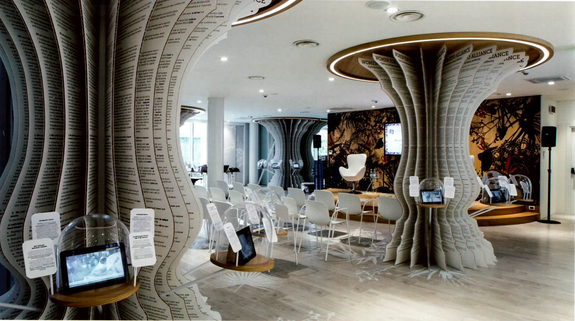 Exhibition space with paper-layered tree-like columns, white chairs and tablets under glass domes – Italian Pavilion at Expo 2015, Milan, Italy – exhibition design