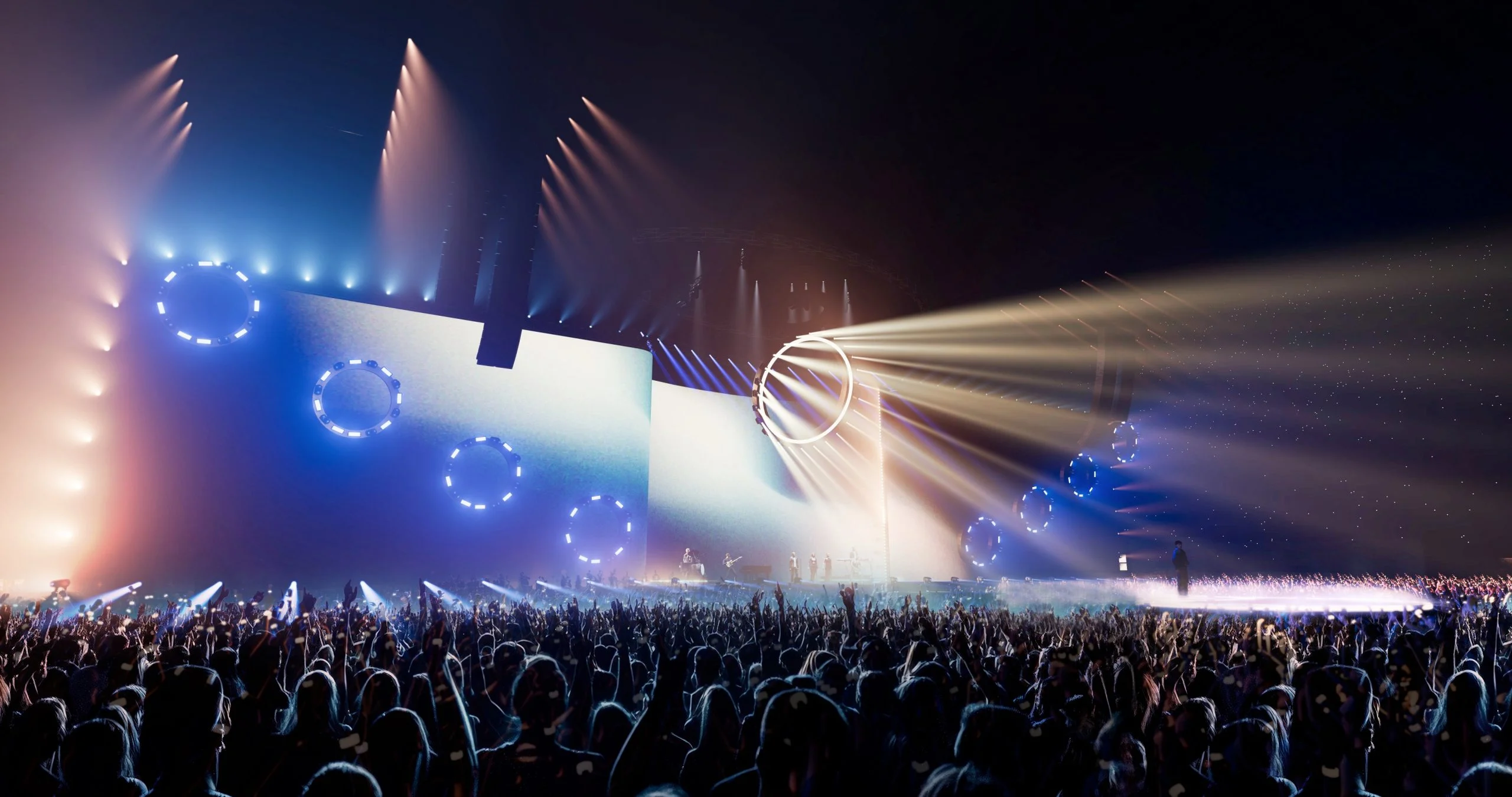 Render of the stage wall with rings of blue lights and warm beams sweeping over the crowd – Cesare Cremonini Live25, Italy, 2025 – concert stage design