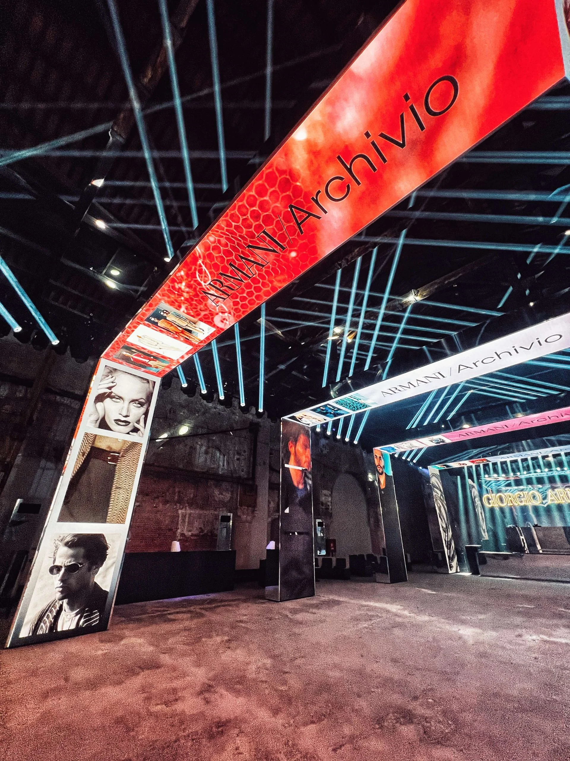 Red LED portal with the Armani/Archivio title and portraits, leaning into the dark hall – Armani/Archivio Party at Venice Film Festival, Italy, 2025 – event design
