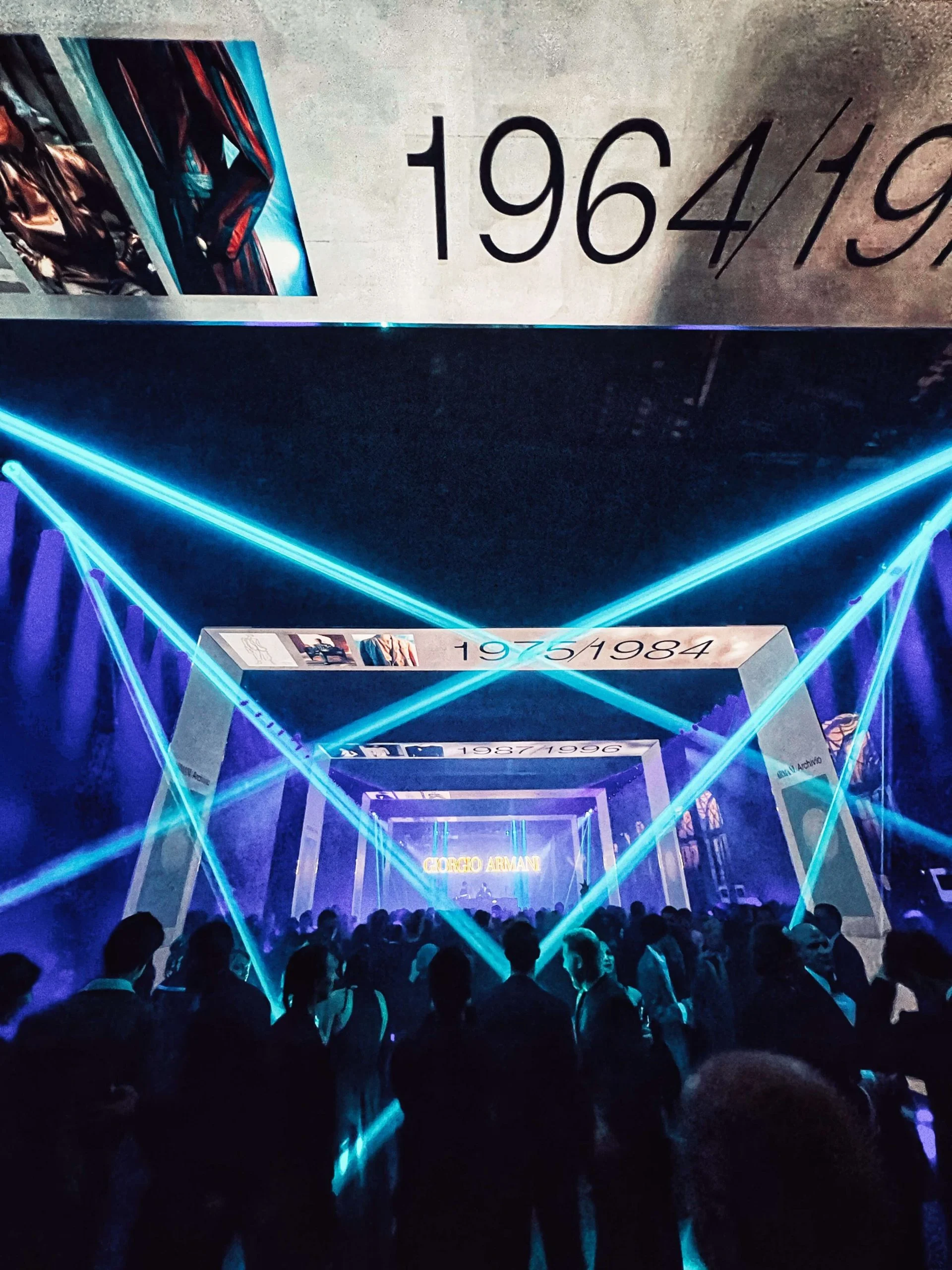 Guests at the party under crossing turquoise laser beams, the corridor of decade portals beyond – Armani/Archivio Party at Venice Film Festival, Italy, 2025 – event design