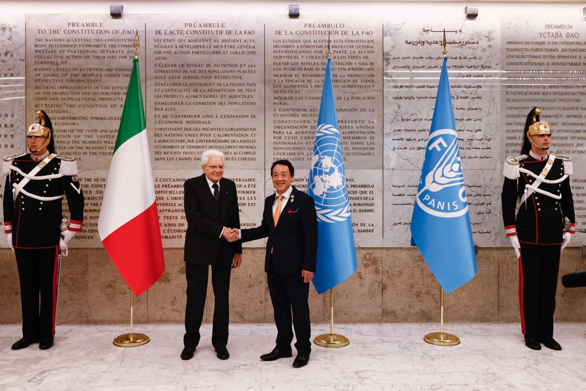 Two officials shaking hands between Italian, UN and FAO flags, honour guards beside the preamble wall – FAO MuNe Food and Agriculture Museum, Rome, Italy, 2025 – exhibition design