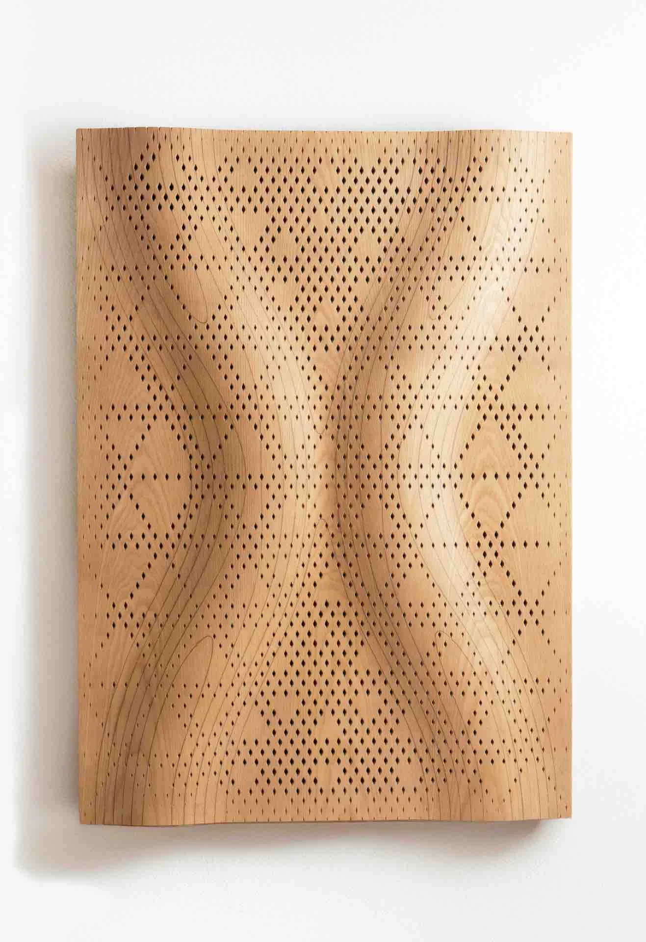 Wavy wooden acoustic panel with a perforated Najdi diamond pattern on a white wall – Najdi Acoustic Panels for Strong by Form, 2025 – product design