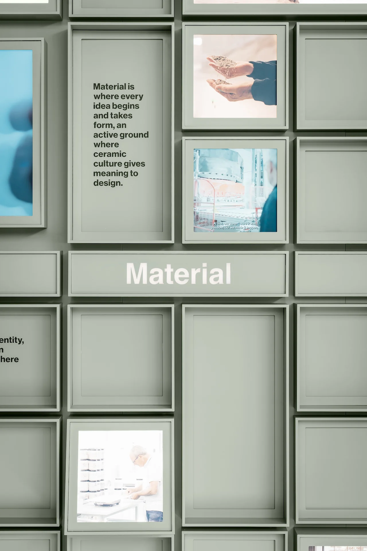 Close-up of the cube grid section titled Material, with text panels and backlit photos – Porcelaingres Brand Narrative Space, Castellarano, Italy, 2025 – showroom design