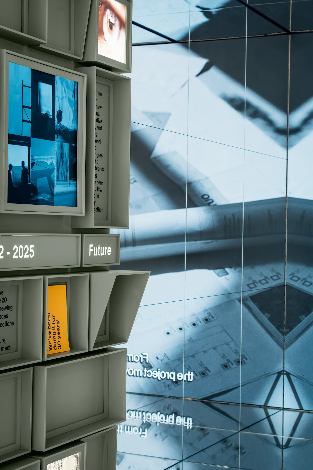 Edge of the cube wall labelled Future beside a large video wall showing technical drawings – Porcelaingres Brand Narrative Space, Castellarano, Italy, 2025 – showroom design