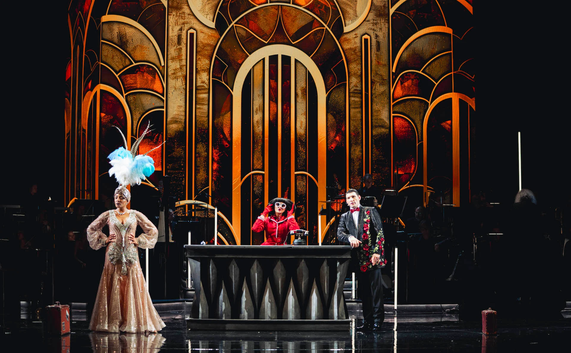 Performers at a bar counter in front of a gold Art Deco backdrop with arched panels – Bonsoir Monte-Carlo, Monte Carlo, Monaco, 2025 – stage design
