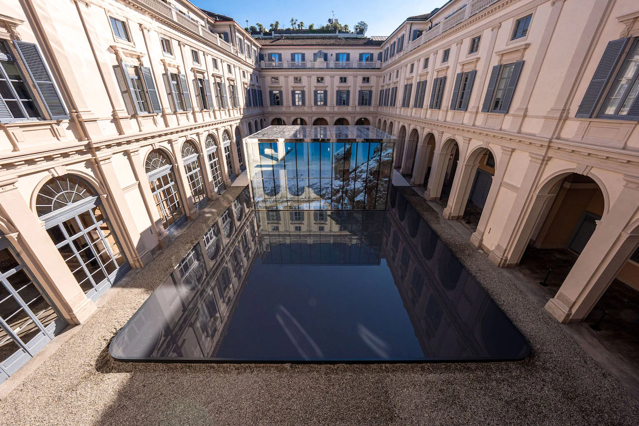 Aerial view of the Palazzo Serbelloni courtyard with a glass pavilion rising from a black reflecting pool – Samsung House at Palazzo Serbelloni, Milan, Italy, 2026 – interior design