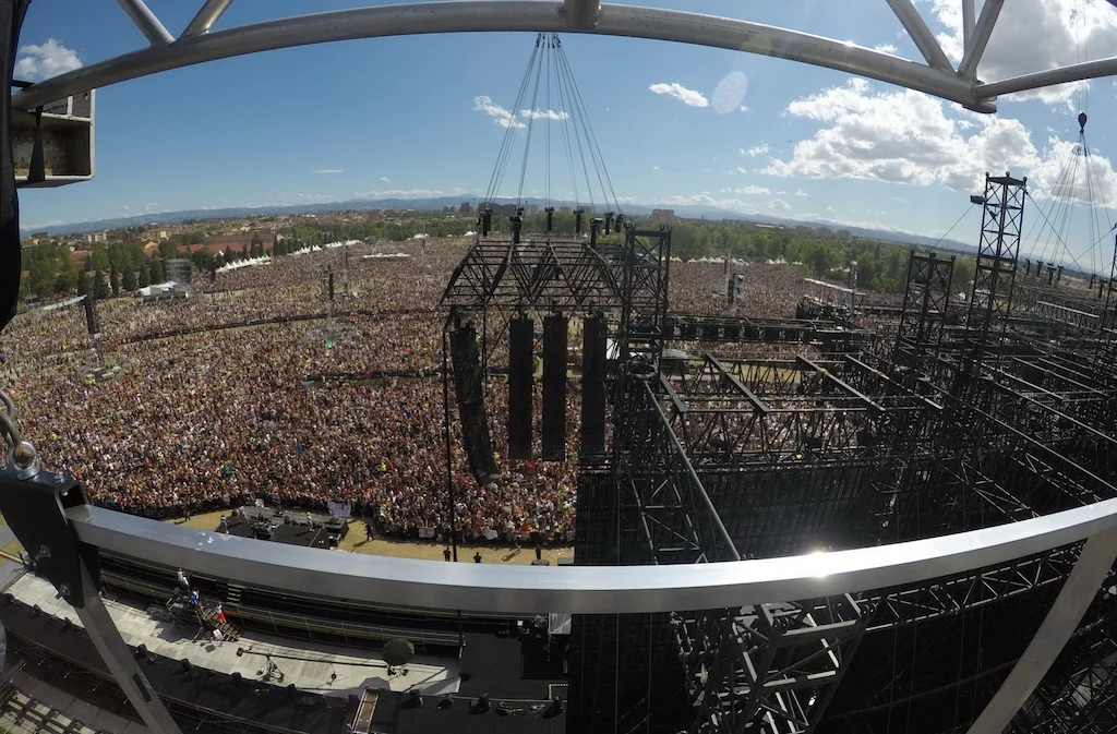 Fisheye view from the top of the stage over the huge Modena Park crowd, with truss towers and hanging speakers – Vasco Rossi Modena Park, Italy, 2017 – concert stage design