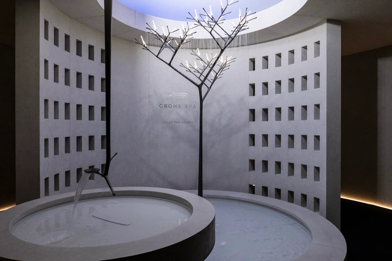 Circular spa room with perforated walls, round water basins and a tree-shaped shower under a skylight – GROHE SPA Aqua Sanctuary at Fuorisalone, Milan, Italy, 2026 – installation design