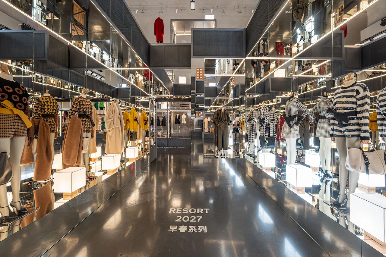 Mirrored corridor lined with mannequins in Resort 2027 looks on illuminated plinths – Max Mara The Max! at Long Museum, Shanghai, China, 2026 – exhibition design