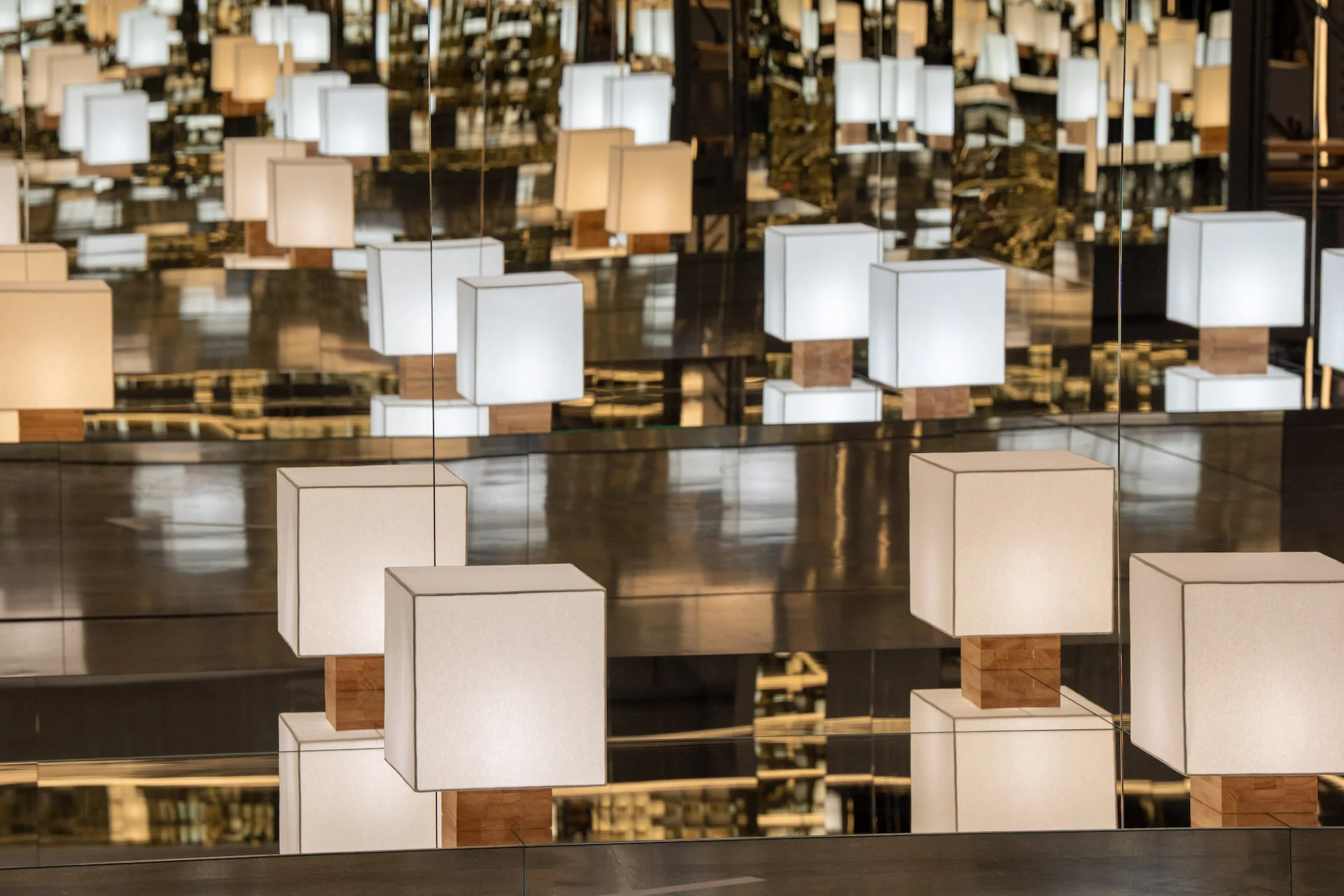 Cube table lamps on wooden bases multiplied endlessly by mirrored walls – Max Mara The Max! at Long Museum, Shanghai, China, 2026 – exhibition design