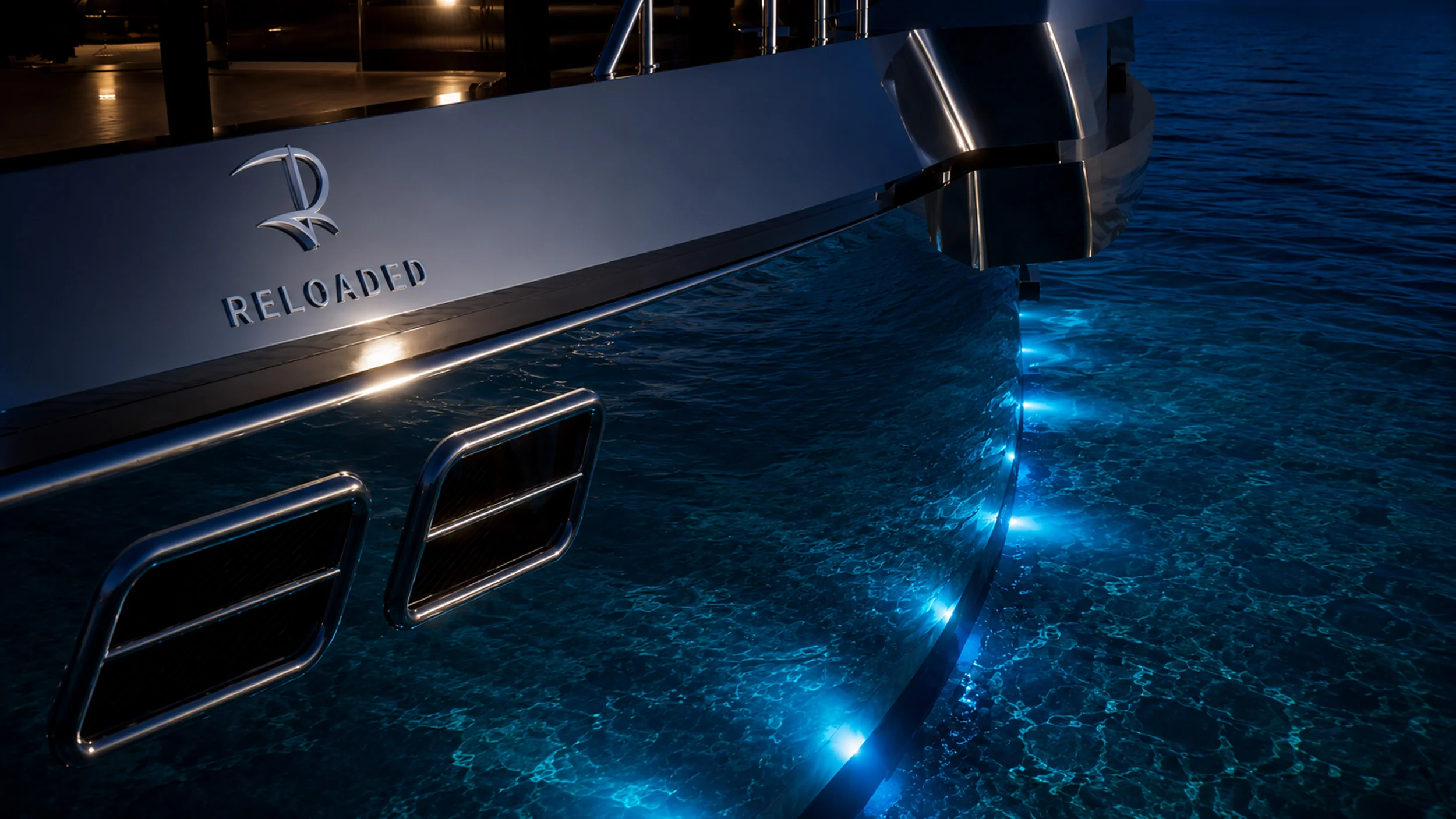 Render of the stern at night: Reloaded logo on the hull and blue underwater lights in the sea – Morricone Reloaded, Flexplorer 146, 2026 – yacht interior design competition